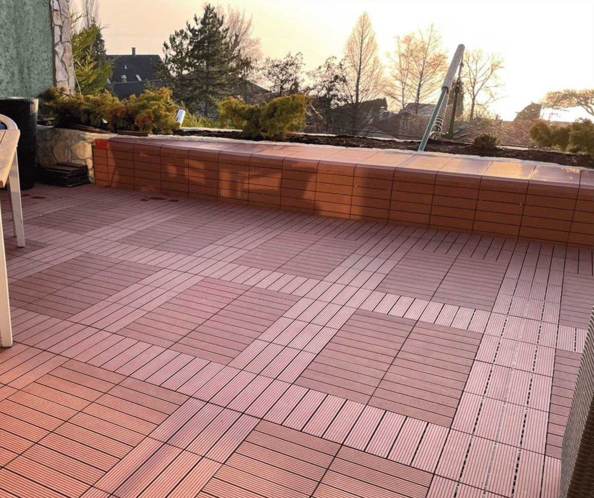 Terrace with wooden interlocking brown patio tiles creating a warm and stylish outdoor flooring design at sunset