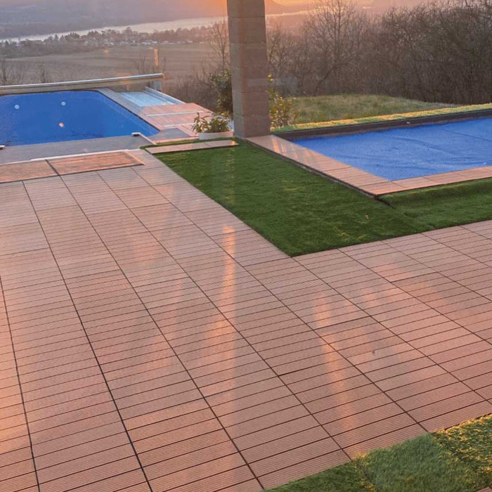 Poolside area with wooden-look patio tiles and artificial grass creating a stylish outdoor flooring design