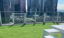 Rooftop terrace with artificial grass and patio tiles, offering a modern outdoor living space with city views